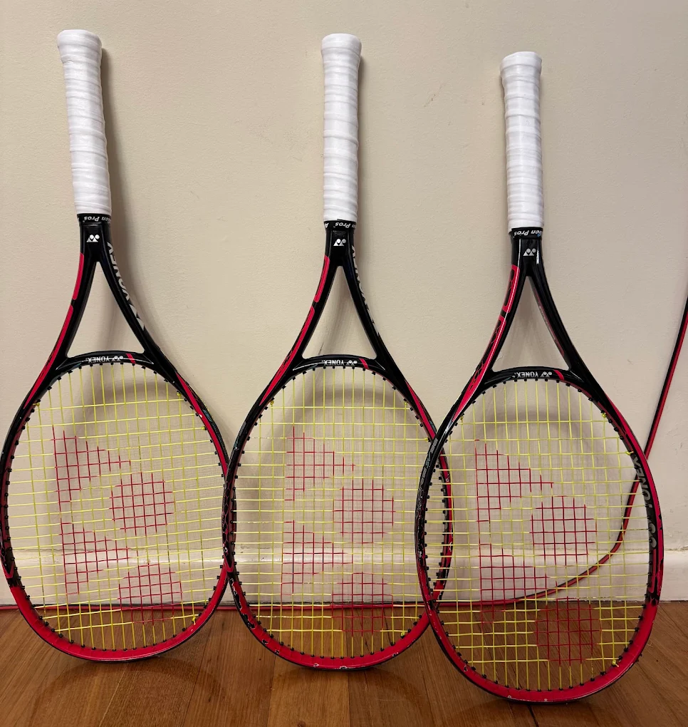 A racquet on the bench, ready for restringing